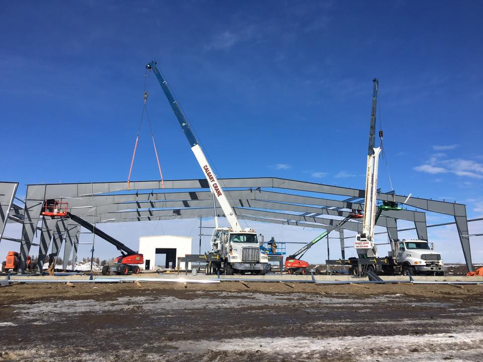 A construction site with cranes and workers.